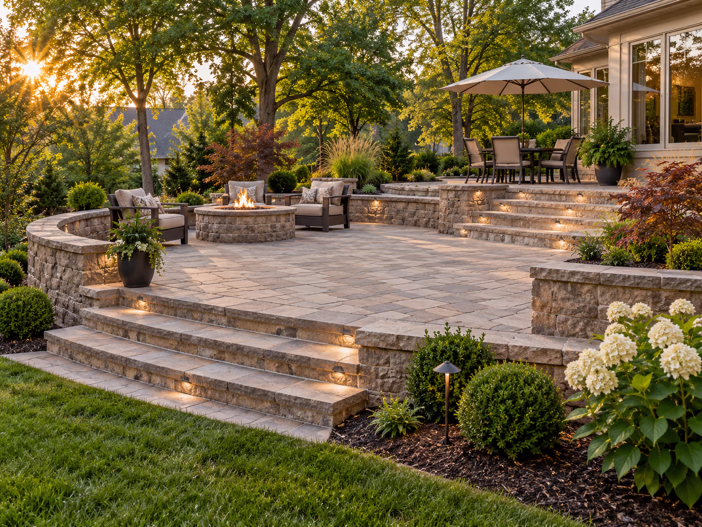 Completed hardscape patio with stone walls and steps