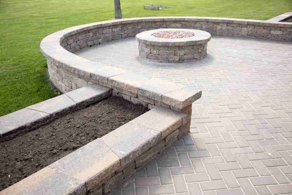 paver patio matching seating wall and flower beds