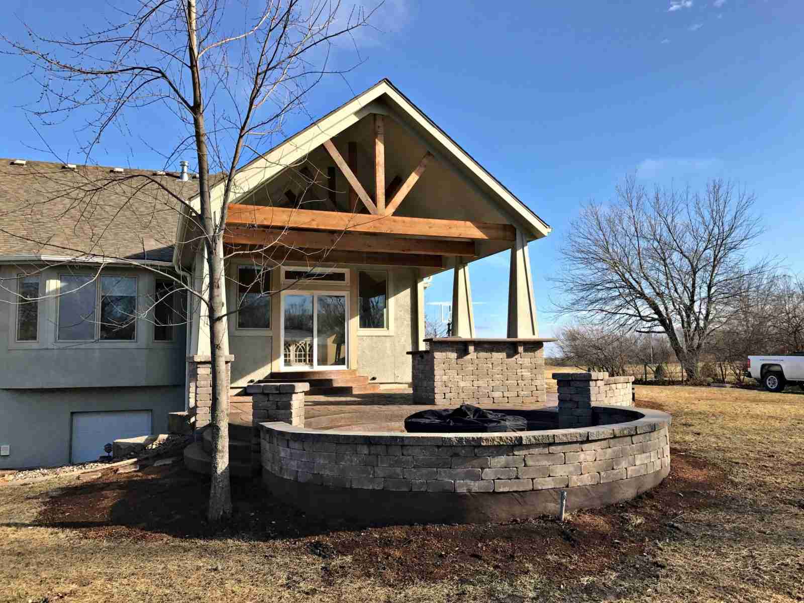 stunning covered structure, grill station, and fire pit area