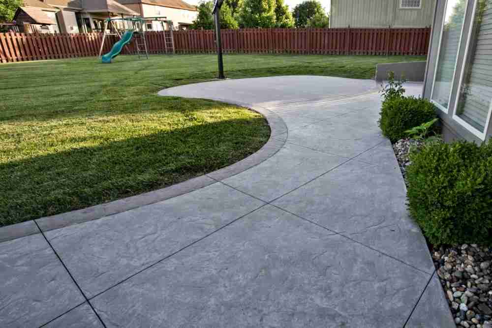 stamped concrete for the patio with decorative cobblestones
