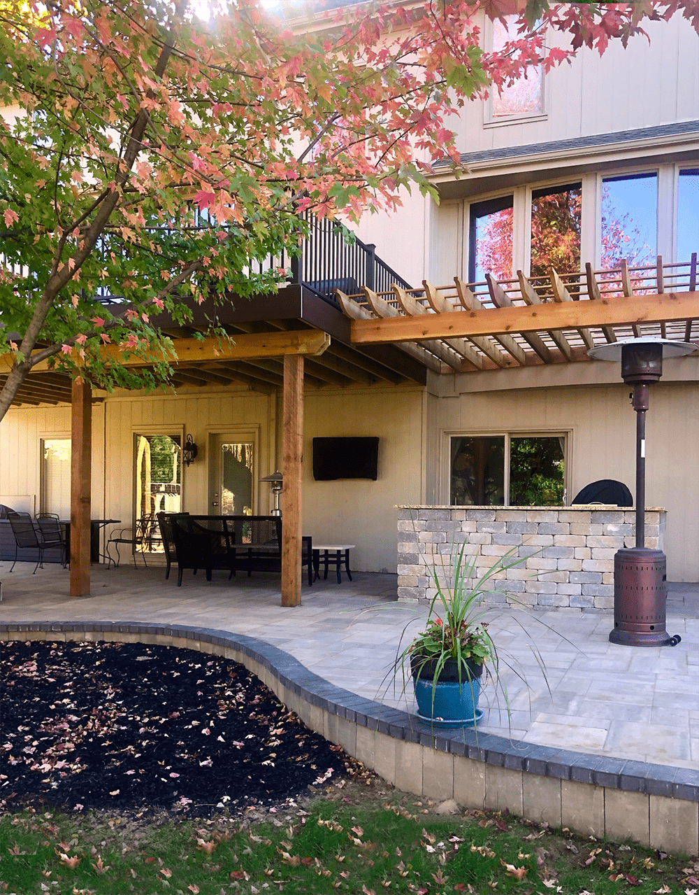 Custom two-story double-decker deck with integrated stairs and lower-level patio area