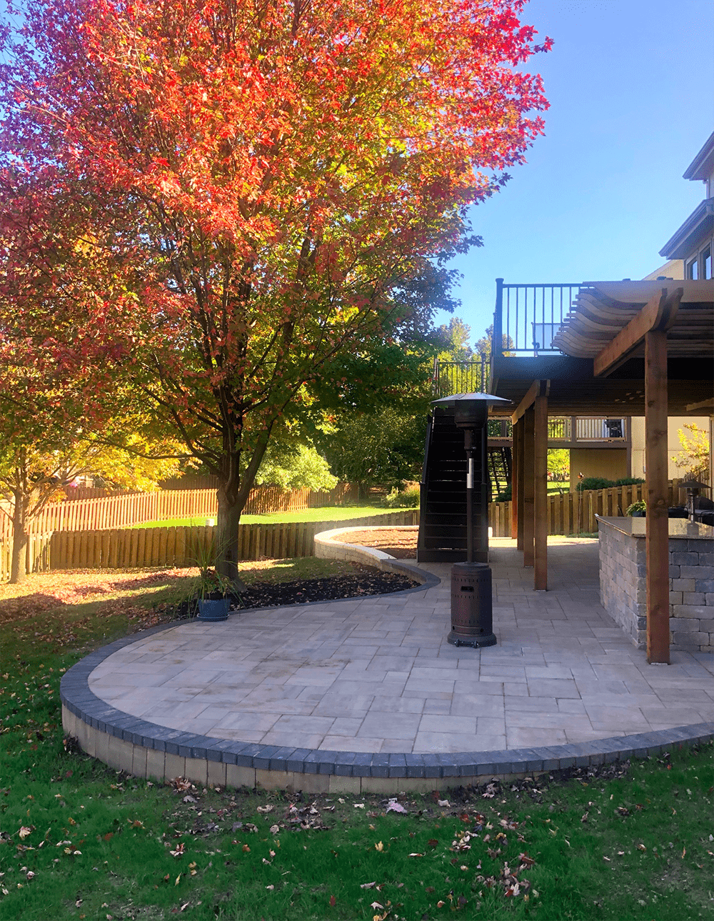 Two-tier composite double-decker deck with under-deck drainage ceiling and perimeter railings