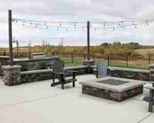 poolside patio featuring a grill station and bar