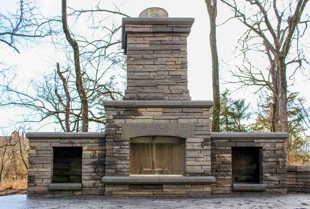 Stone outdoor fireplace on a paver patio