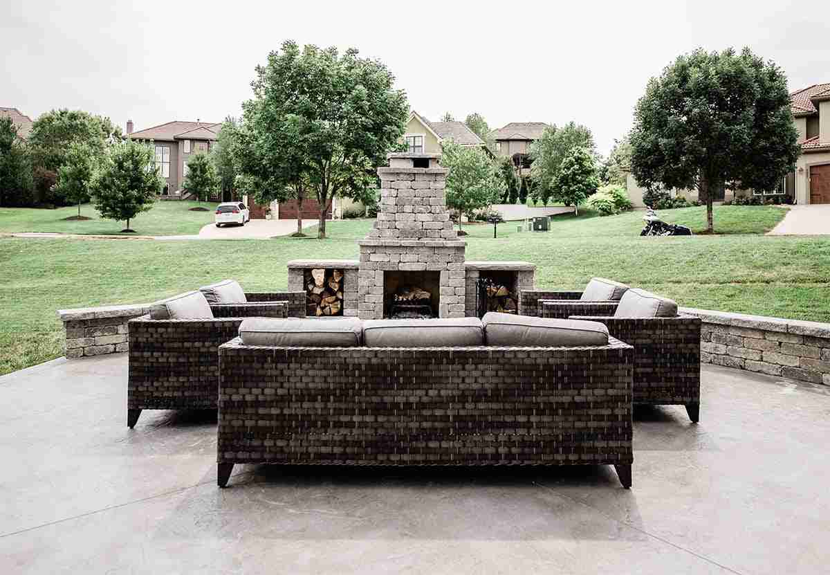 Outdoor fireplace with sofa seating arranged around it